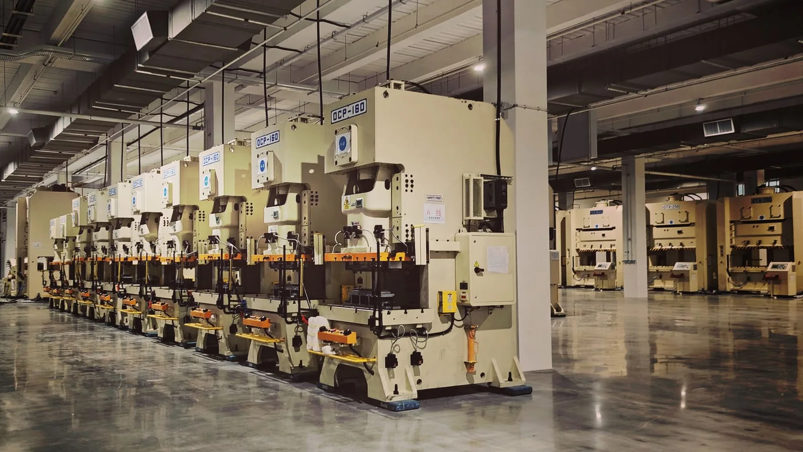 Industrial press machines arranged in a production hall; illustrative stock photograph
