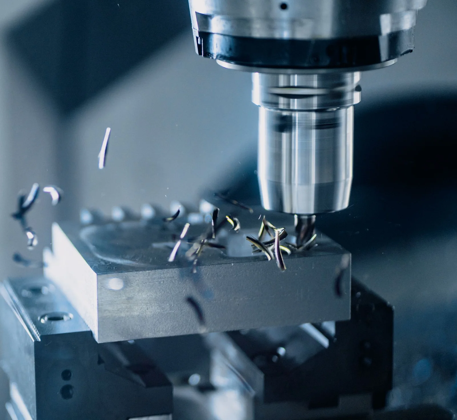 Close-up of a CNC milling machine working a metal component; illustrative stock photograph